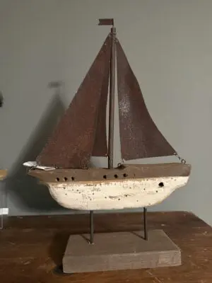 Rustic decorative wooden sailboat with brown sails