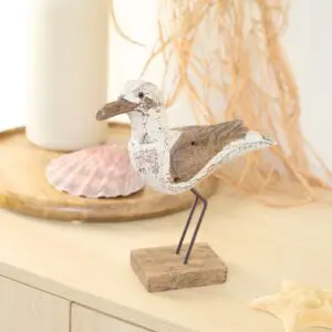 Rustic wooden seagull figurine on stand
