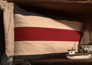 Nautical pillow with red stripe and toy boat