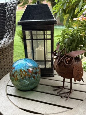 Black lantern, turquoise gazing ball, metal owl planter