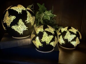 Three glowing butterfly cutout decorative globe lamps