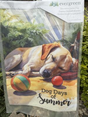 Sleeping dog with balls on summer garden flag