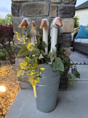 Decorative goose planter in galvanized metal bucket
