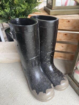 Worn black children's rain boots