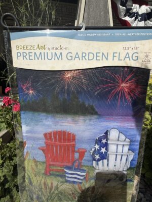 Garden flag showing chairs by lake, fireworks