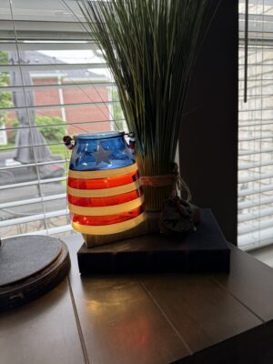 American flag glass lantern on windowsill