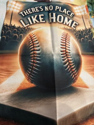 Baseball on home plate under stadium lights